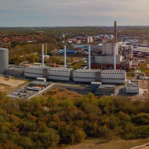 View of coastal power station with steam accumulator. The modular gas engine cogeneration plant in Kiel. Combined heat and power station for heat engine and power station to generate electricity.