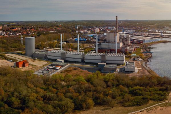 View of coastal power station with steam accumulator. The modular gas engine cogeneration plant in Kiel. Combined heat and power station for heat engine and power station to generate electricity.